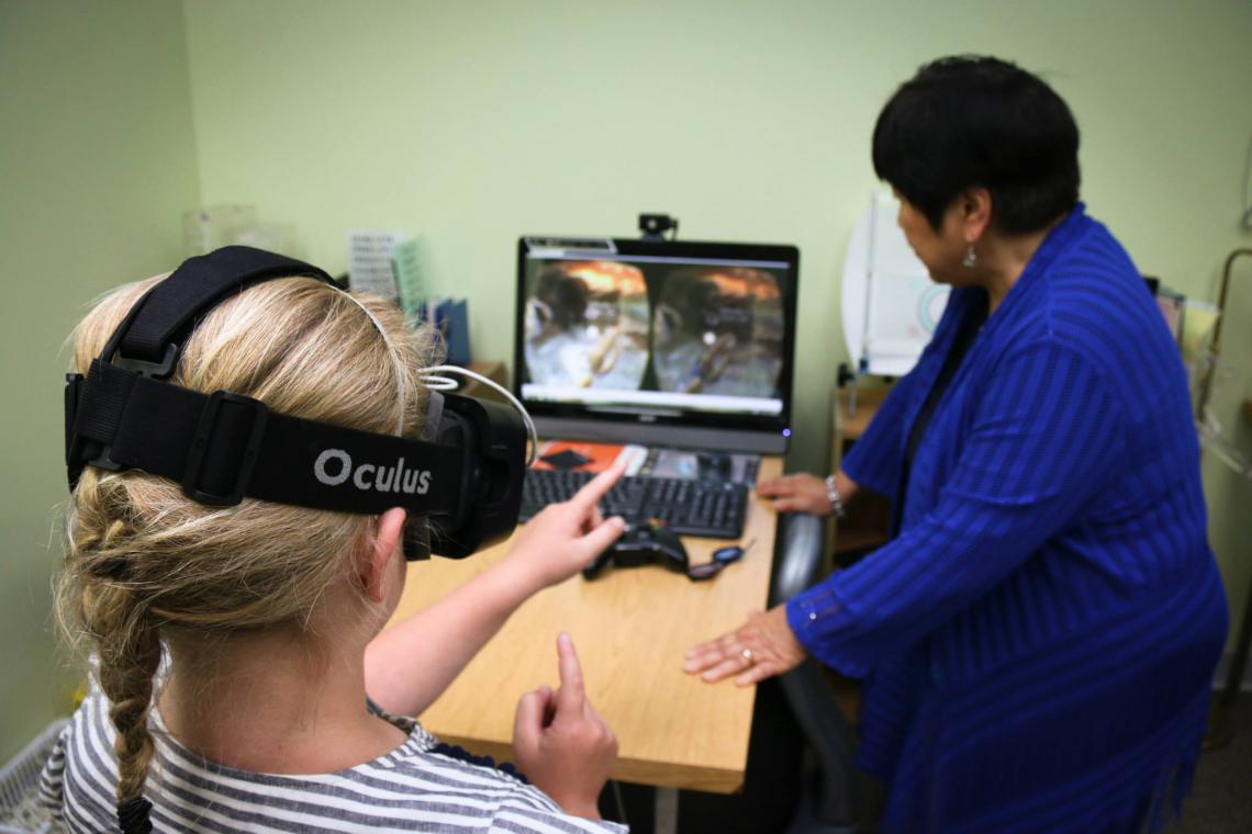 Dr. Mary VanHoy using Vivid Vision with a patient at her clinic in Indianapolis.